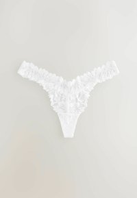 White lace thong featuring intricate floral patterns, scalloped edges, and a minimalist design. Soft texture with no visible hardware.