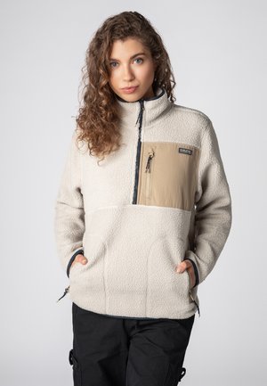 Fleece-Pullover in Off-White mit einer beigen Fronttasche, Reißverschluss und zwei Seitentaschen; verfügt über einen strukturierten Stoff und kontrastierende Bündchen.