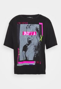 Zwart t-shirt met korte mouwen met een grafische print bestaande uit een grijze afbeelding, roze accenten en neon groene lijnen. Casual, ontspannen pasvorm.