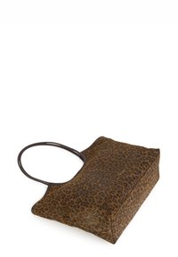 Brown tote bag with dark leopard print pattern and black rounded handles, angled on a white background.