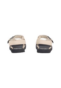 Beige and black sandals with adjustable straps, shown from the back on a white background.