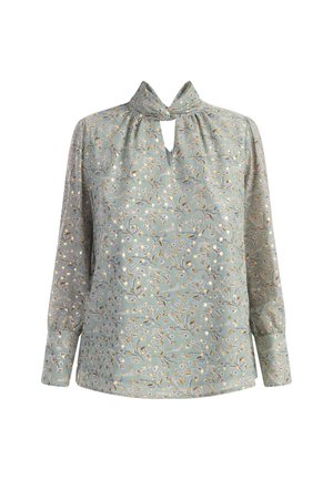 Langærmet bluse i lys grøn stof med blomsterprint. Har en delt halsudskæring og samlinger ved skuldrene for ekstra struktur.