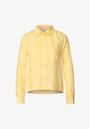Gul linned skjorte med knap-ned krave, lange ærmer og to brystlommer. Nederkant er let rundet. Struktureret stof.