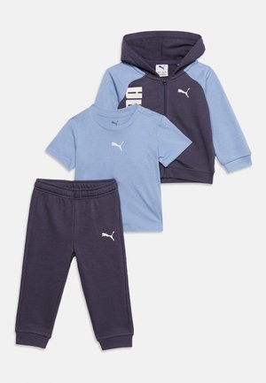 Ensemble survêtement trois pièces pour enfants Puma comprenant un tee-shirt à manches courtes bleu clair, un sweat à capuche zippé bleu foncé avec manches bleu clair, et un pantalon bleu foncé assorti.