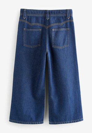Džínové culottes v tmavě modré barvě s klasickým přímým střihem. Obsahují dvě zadní kapsy a kontrastní žluté prošívání podél švů.
