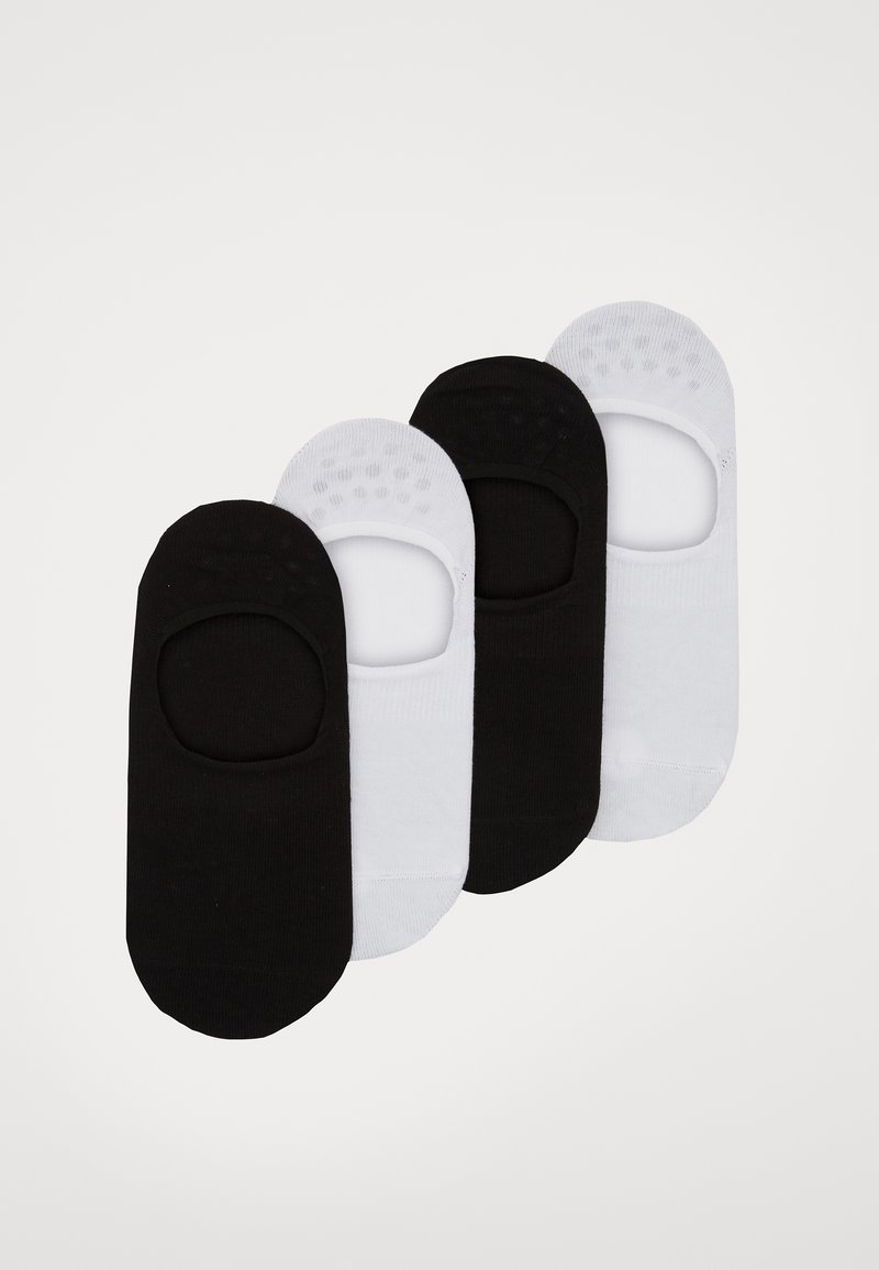 Vier Paare von Fußsocken im niedrigen Schnitt, zwei schwarz und zwei weiß. Hergestellt aus einem glatten Stoff mit Anti-Rutsch-Punkten auf der Innenseite der schwarzen Paare.