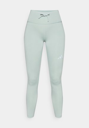 Svijetlo zelene sportske tajice s visokim pojasom, utezom za vezanje i bijelim logotipom na lijevom bedrima. Glatki, rastezljivi materijal.