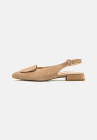 Beige suede slingback shoe with a pointed toe and flat block heel. Features a rounded flap accent and an adjustable button strap.