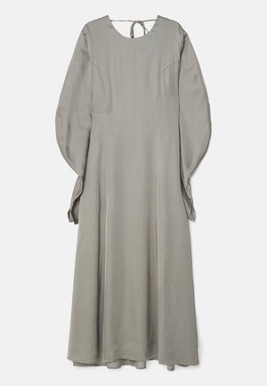 Long, gray dress made of smooth fabric, featuring a round neckline, long sleeves, and a tie closure at the back. Simple, flowing design.