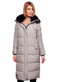 Long gray puffer coat with a black faux fur collar, zip and snap closures, side pockets, and quilted design.