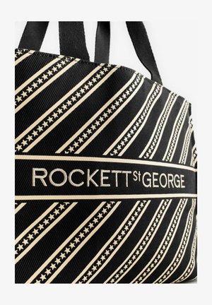 Czarna torba na ramię z płótna z ukośnymi beżowymi paskami i wzorami gwiazd. Na środku znajduje się wyhaftowany napis "ROCKETT st GEORGE".