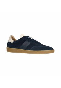 Marineblauwe suède sneaker met een crèmekleurige hak en gumzool, voorzien van een gestructureerd zijpaneel en ronde veters. Ontworpen voor casual gebruik.