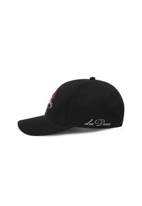 Black cap featuring a curved visor, embroidered rose design in red, and text "Les Deux" in white on the side. Soft fabric texture.