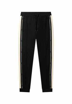 Pantalons de sport noirs avec des bandes latérales crème, taille élastique et poignets. Comprend des poches zippées pour une fonctionnalité supplémentaire.