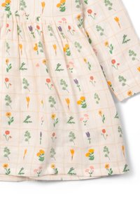 Baumwollkleid mit einem hellbeigen Hintergrund, das ein Rautenmuster aus bunten Blumenprints in verschiedenen Formen und Größen zeigt.