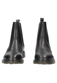 Botas Chelsea de cuero negro con paneles elásticos en los laterales, punta redonda y tirador, con una suela de goma texturizada para mayor agarre.