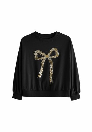 Sweatshirt noir à manches longues et encolure ronde, avec un motif de nœud en or et pierres précieuses sur le devant et un ourlet élastique.