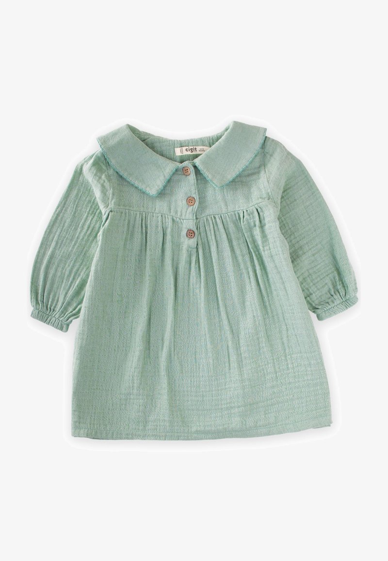 Jasnozielona bawełniana sukienka z kołnierzykiem, z zapięciem na guziki oraz marszczonym pasem. Posiada długie bufiaste rękawy i teksturowany materiał.
