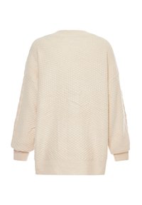 Maglione a maglia con texture di colore crema, maniche lunghe, polsini a coste e orlo a coste visto da dietro.