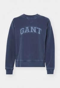 Mornarska dukserica od pamuka, s rebrastim okovratnikom, dugim rukavima, elastičnim manžetama i izvezenim logom "GANT" na prednjoj strani.