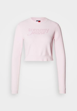 Svijetloružičasti kratki pleteni džemper s dugim rukavima i zaobljenim izrezom. Na prednjoj strani utisnut je logo "Tommy Jeans". Mekana tekstura.