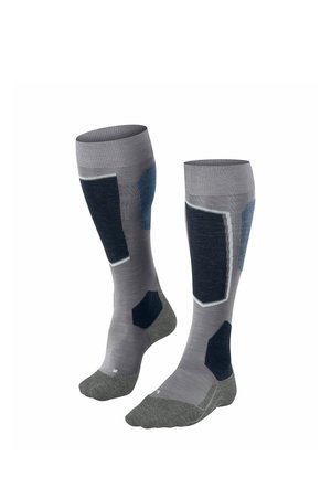 Grijze kniekousen met donkerblauwe en grijze geometrische patronen, verstevigde delen en een getextureerde zool voor grip.