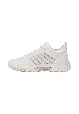 Chaussure de sport blanche basse avec tige texturée et semelle antidérapante, vue de côté sur un fond blanc uni.