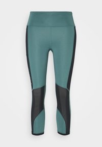 Turkoosi ja musta urheiluleggingsit korkealla vyötäröllä, verkkopaneeleilla ja kaarevalla saumarakenteella lisäämään muotoa ja tukea.