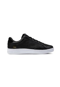Black athletic sneaker made of smooth leather with perforated detailing, white rubber sole, and contrasting gold accent displaying “1966.”