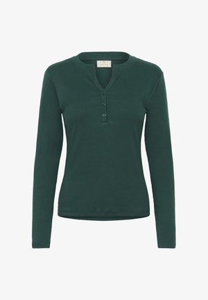 Haut henley à manches longues en teinte sarcelle, en tissu côtelé, avec un col arrondi et une patte de boutonnage à trois boutons à l'avant.