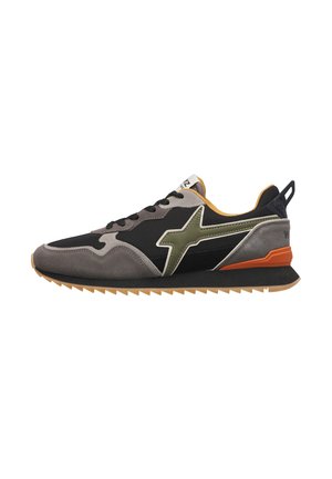 Low-top sneaker with black, grey, and orange colors, green star design on the side, black laces, and a gum-colored ridged sole.