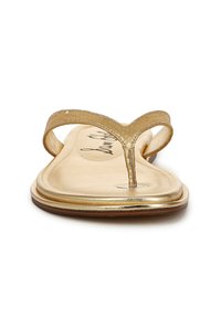 Sandali piatti oro con una sottile fascia testurizzata e design con inserto per le dita. La soletta è liscia e metallica, con un bordo leggermente rialzato.