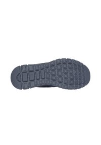 Suela de zapato en goma gris, con una superficie texturizada que presenta un patrón de rejilla y lengüetas de tracción distintas para un mejor agarre.