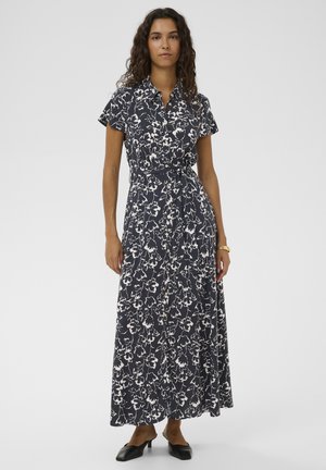 Abito lungo blu navy a fiori con maniche corte, chiusura frontale con bottoni, cintura in tessuto e texture fluida. Decorato con motivi floreali bianchi.