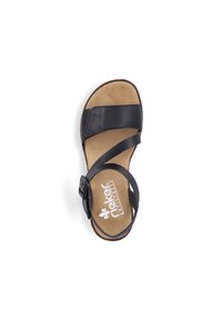 Black leather sandal with cross straps, adjustable buckle, and cushioned tan insole, featuring a round toe and lightweight design.