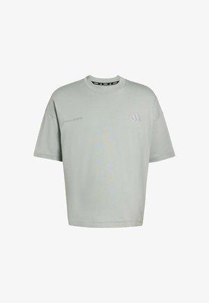 Light green oversized t-shirt made of soft fabric. Features short sleeves, a round neckline, and subtle printed branding on the front.