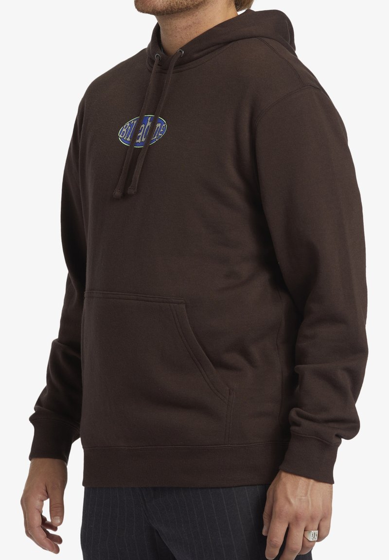 Sudadera marrón hecha de un tejido suave, con un bolsillo frontal, capucha con cordones y un logo colorido en el pecho. Corte holgado y puños de canalé.