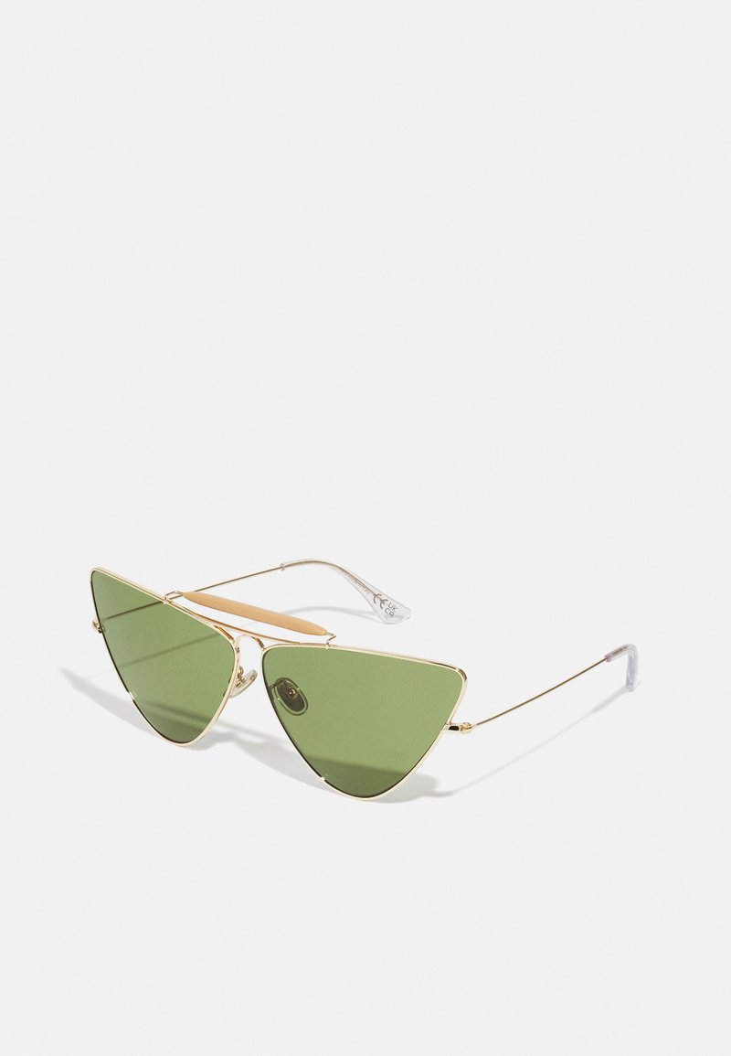 Green tinted cat-eye sunglasses with a gold metal frame, featuring a double bridge and clear plastic ear tips for comfort.
