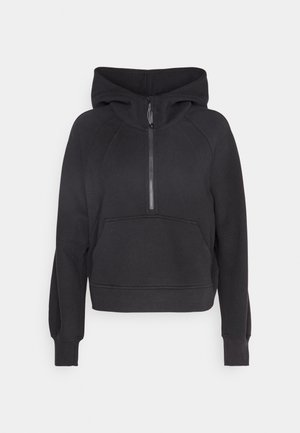 Must värviline kapuutsiga sviiter, millel on pool tõmblukk, eesmine tasku ja ribidetega ääred. Valmistatud pehmest kangast, omab lühendatud lõiget ja raglanvarrukaid.