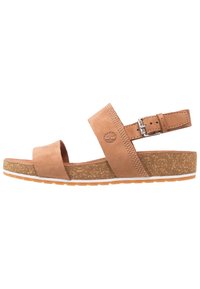 Brune lær åpen-tå sandal med korksåle, justerbar ankelrem med sølvspenne, og preget tre-logo på side-remmen.