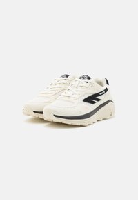 White athletic shoes with black accents. Features a mesh upper, padded tongue, and cushioned sole. Textured materials enhance grip and support.