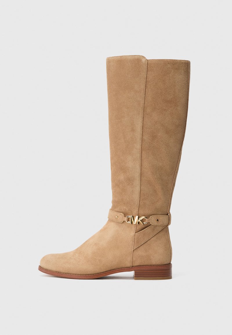 Tall tan suede boot with low wooden heel and gold "MK" logo buckle on ankle strap, shown in side profile on white background.