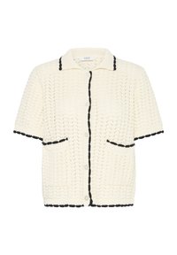 Cardigan en tricot à manches courtes couleur crème, avec bordure noire sur le col, la ligne de boutons, les poches, les manches et l'ourlet, présentant un motif texturé en maille ouverte.