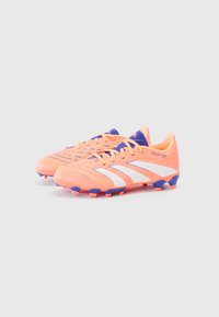 Pair of orange soccer cleats with white stripes, blue accents, and studs, set against a plain light background.