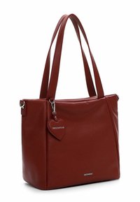 Red leather tote bag with two shoulder straps, textured surface, metallic keychain in heart shape, and small brand logo on the front.