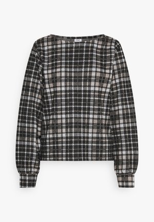 Haut à manches longues à carreaux noir et blanc avec un col rond. Tissu texturé et poignets élastiqués pour une coupe ajustée.