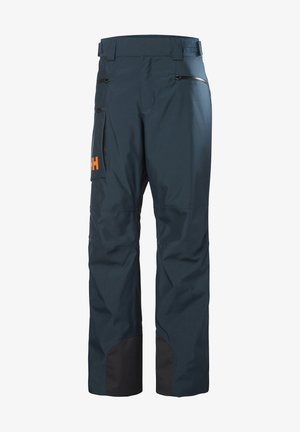 Navy blue waterproof pants with a black bottom hem, zippered pockets, adjustable waist, and an orange logo on the side.