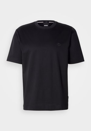 Czarny bawełniany t-shirt z okrągłym dekoltem, krótkimi rękawami i małym wyszywanym logo na piersi. Gładka faktura, luźny krój.