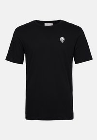 Black cotton T-shirt with short sleeves and crew neck. Features a small white skull graphic on the left chest area. Soft texture.