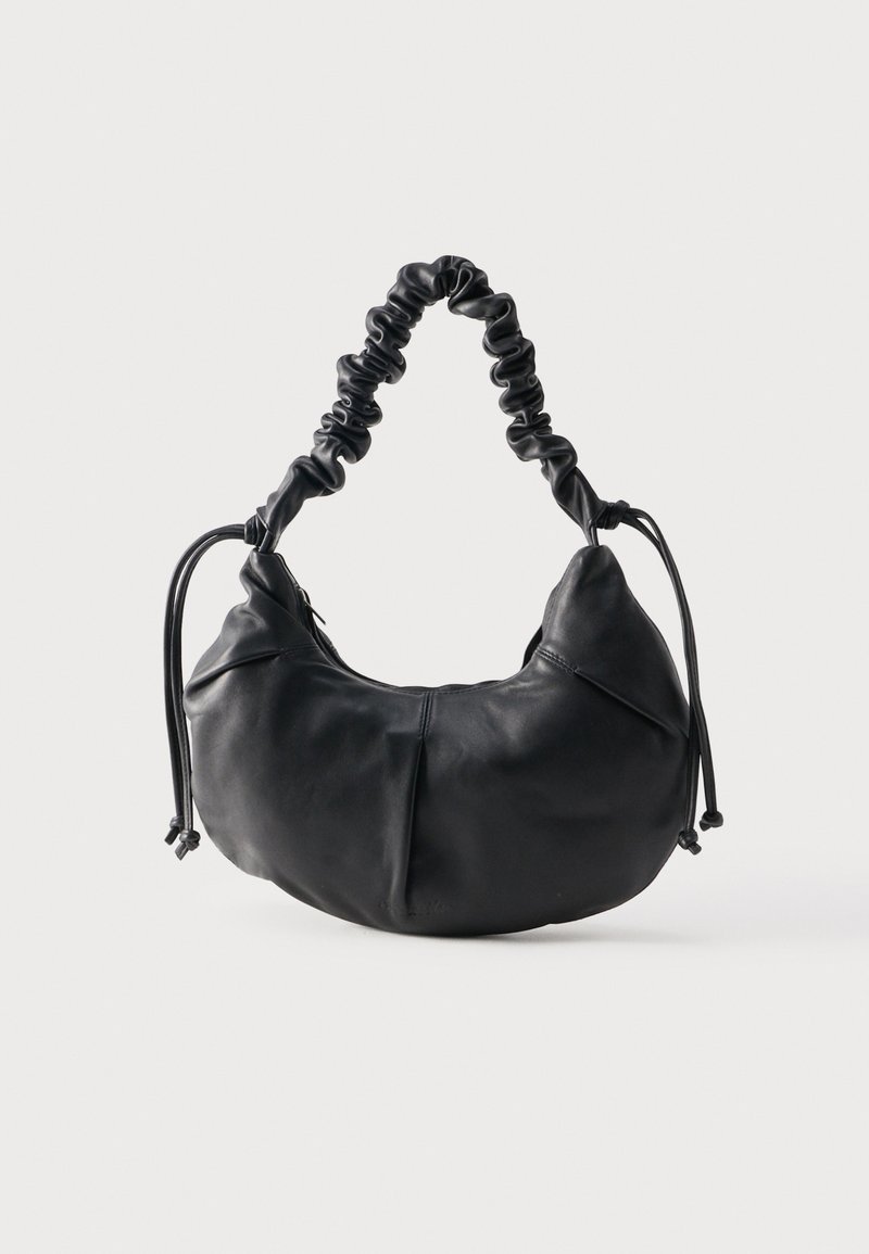 Soft black leather shoulder bag with ruched handle and drawstring ties on a neutral background.